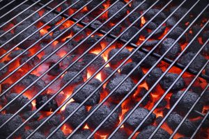 BBQ Grill And Glowing Hot Charcoal Briquettes In The Background, Close-Up, Top View. Concept For Outdoor Barbecue Party Or Picnic Or Cookout
